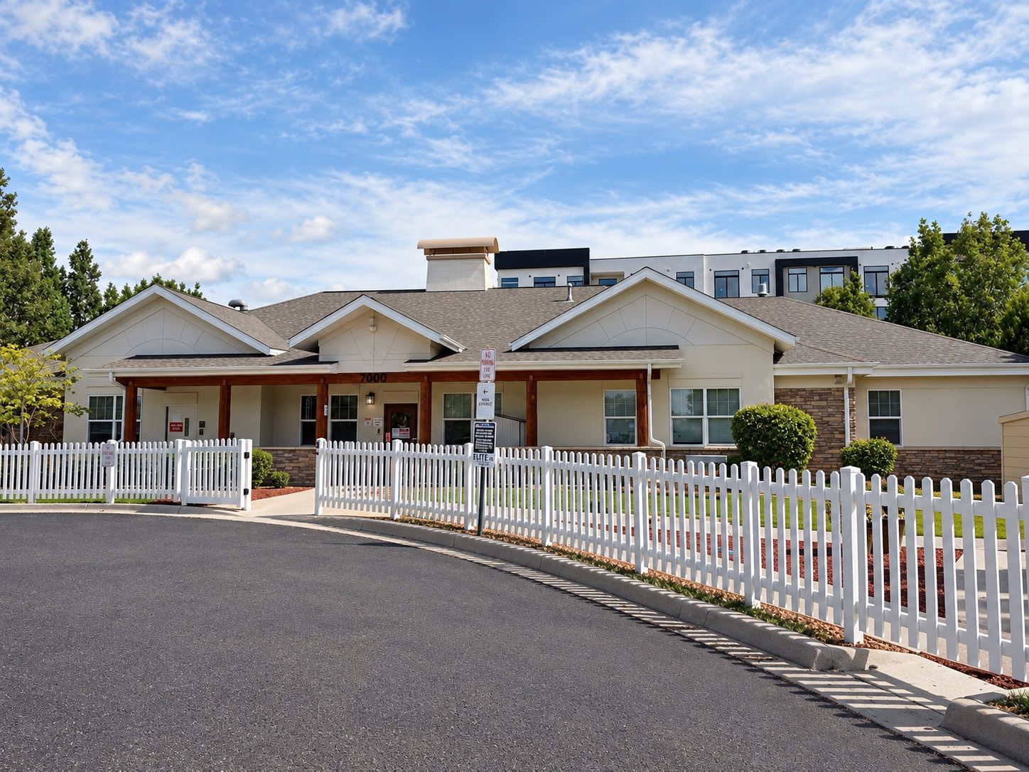 Front of the 7000 building behind its white picket fence