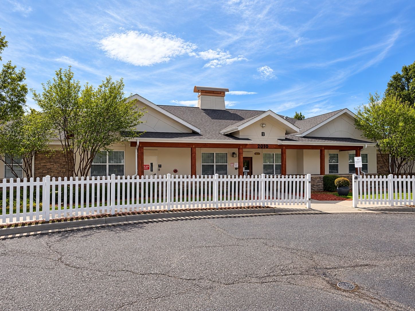 Front of building B behind its white picket fence