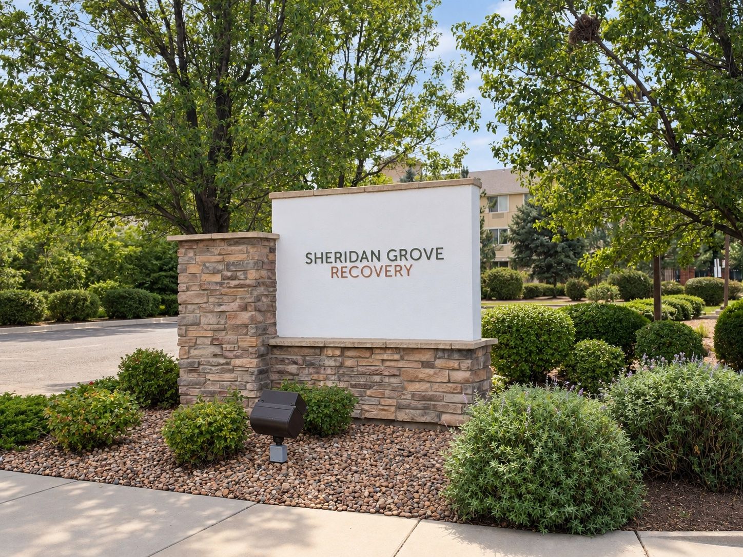Sheridan Grove Recovery entrance sign among the trees