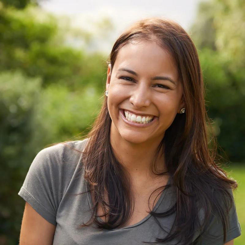 A woman smiles at the camera. She is thriving in treatment at Sheridan Grove Recovery.