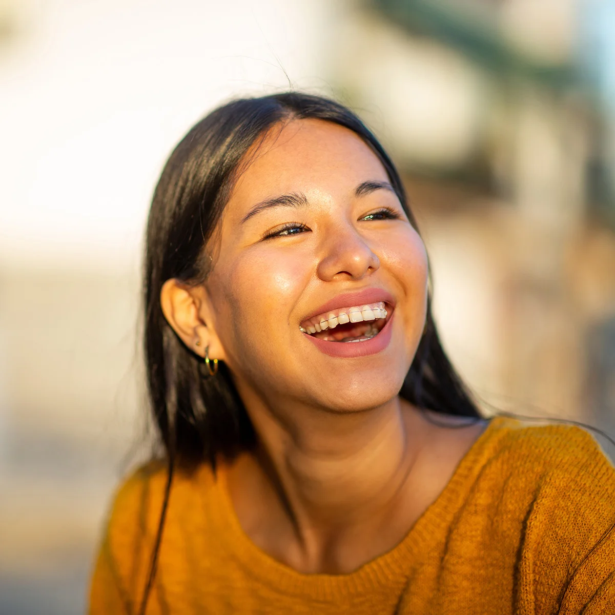 A girl with braces is smiling at sunset. She just learned what to expect at Sheridan Grove Recovery.