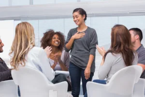 Woman standing up in group therapy session